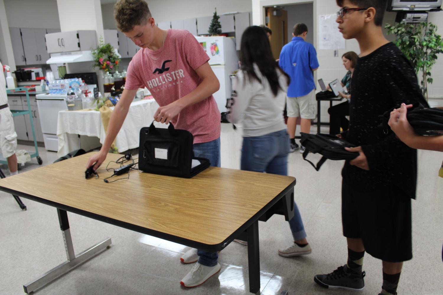 Erin Kirkland
DMS eighth-graders Chase Hightower and Julian Juarez check out their Chromebooks.