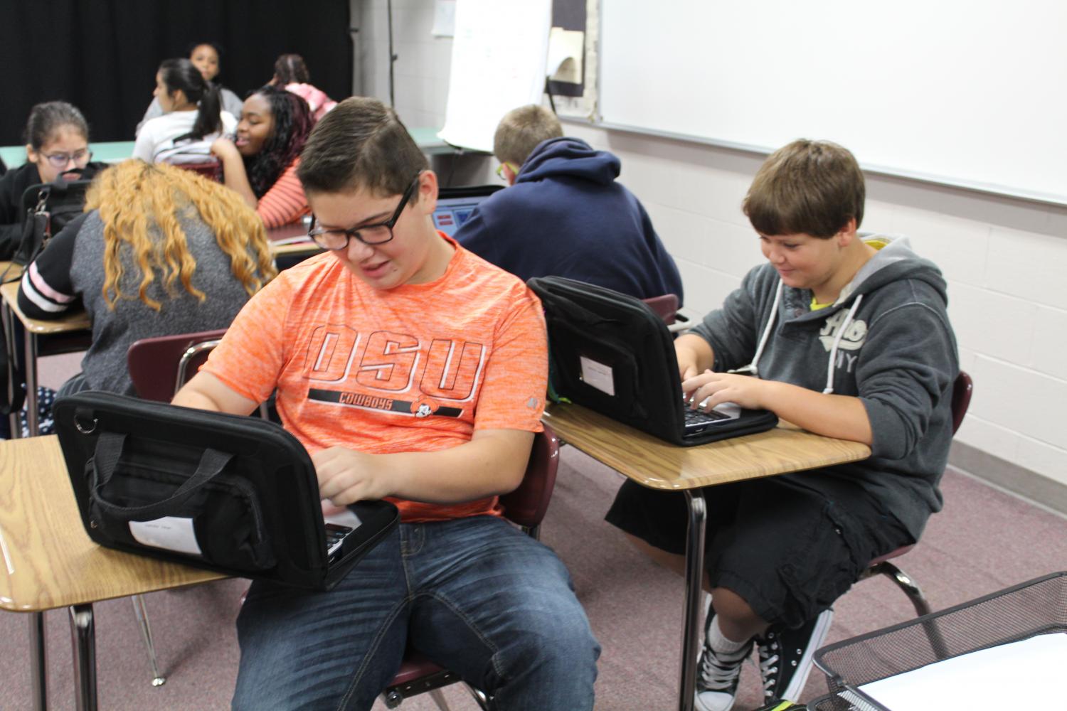 Ethan Swindler, left, and Sebastian McKinnon work on their Chromebooks during Late Start Monday.