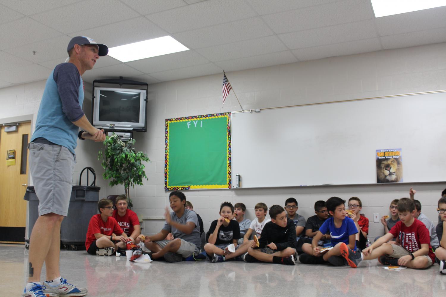 Jimmy Harwood visits with DMS seventh-graders during the first FCA meeting of the school year.