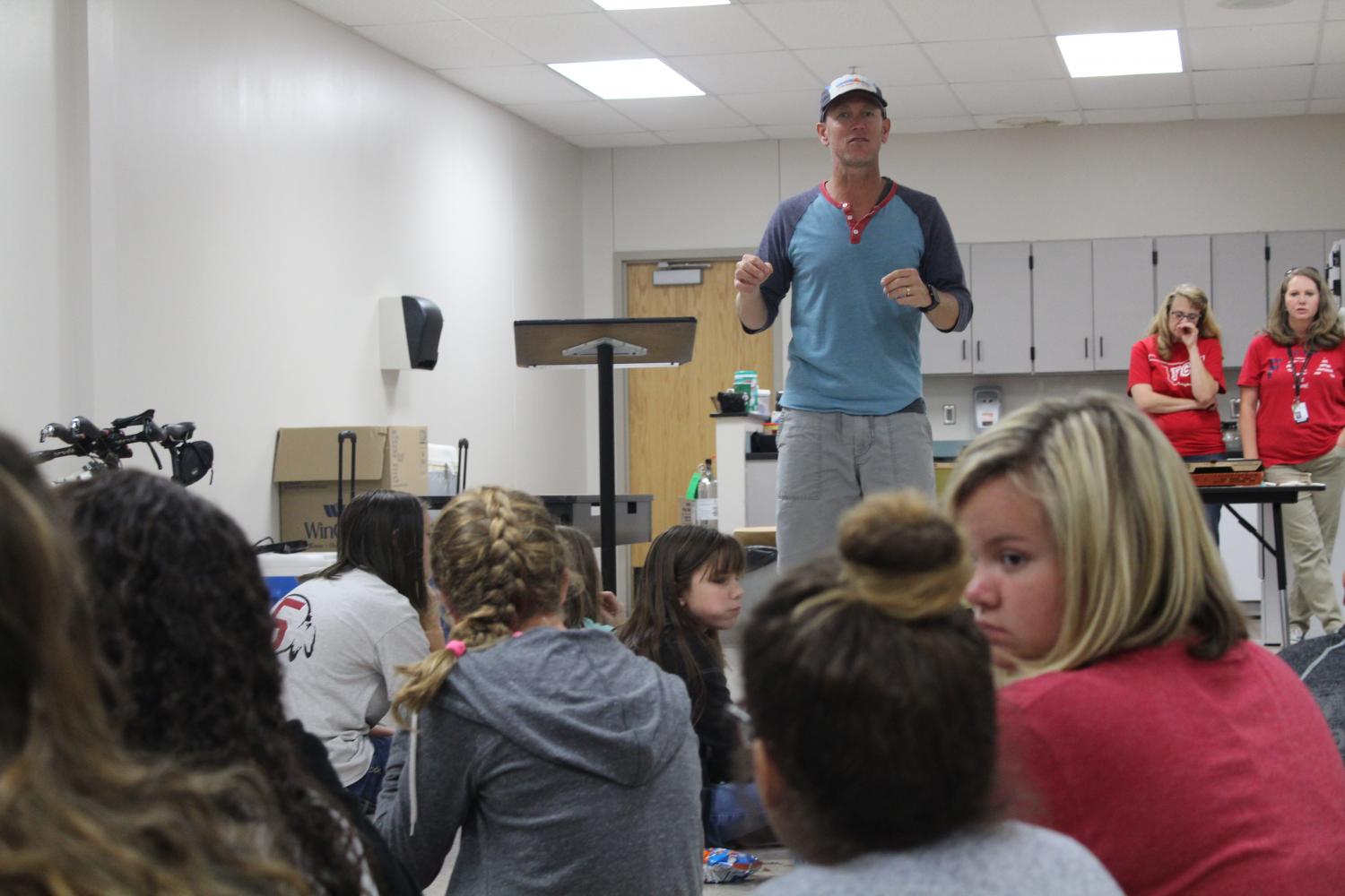 Jimmy Harwood, tri-athlete talks to sixth-grade students Wednesday during FCA.