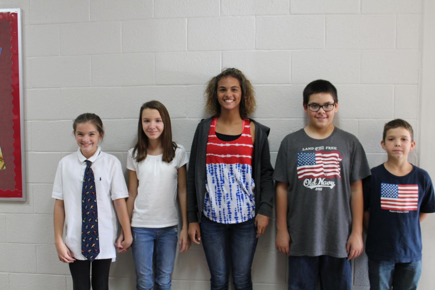 Sixth-grade students Ainsley McEntire, Patience Eichler, Jaedyn Harvey, Morgan Elliot and Travis Fowler show off their gear for Americna Dad Monday.