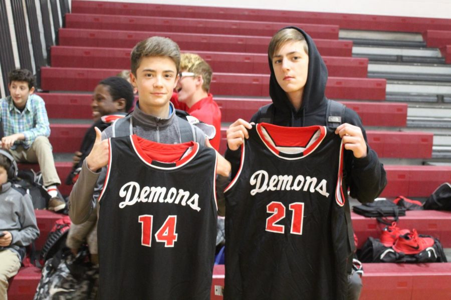 Eighth-grade basketball players show off their jerseys before leaving for Lawton MacArthur.