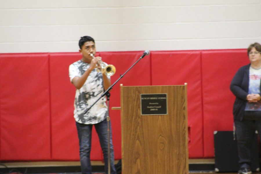 Oscar Diaz performs TAPS during the Veterans Day assembly.