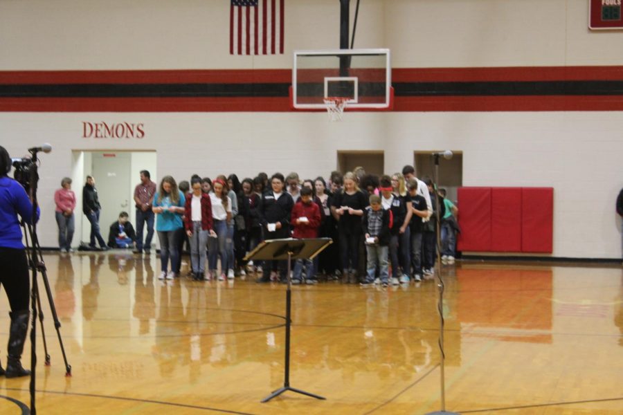 Eighth-grade students recite a poem for the Veterans Day assembly.