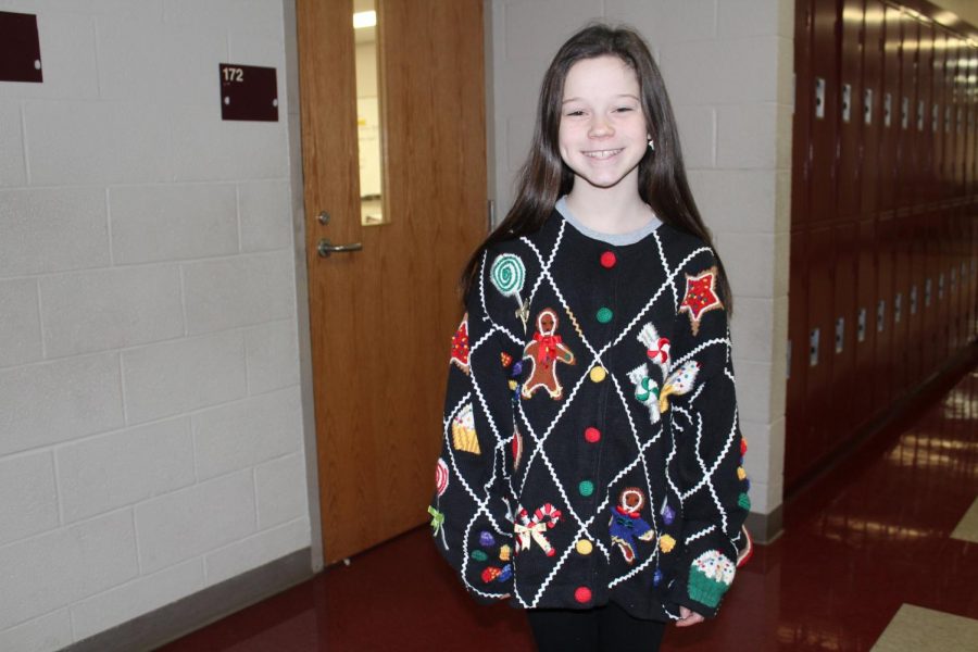 Abbie Scott, sixth-grade student, shows off her Christmas spirit with her holiday sweater.