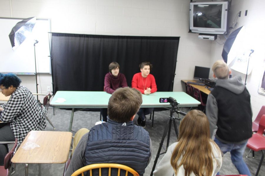 Jack Baldwin and Acacia Luke talk about competitions coming up for band and choir, while other Broadcast Club members working to film and give direction.