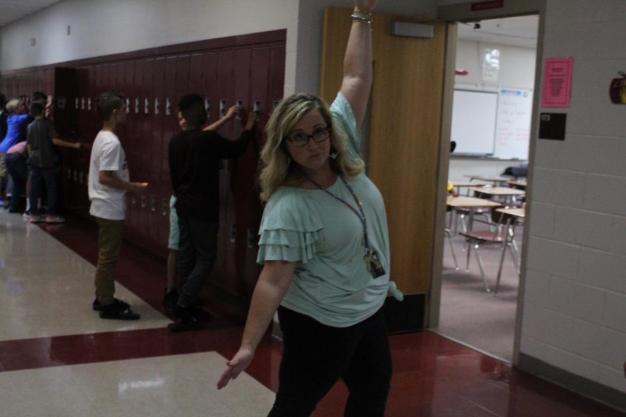 Sixth-grade math teacher Marinda Cook celebrates the first day of school.