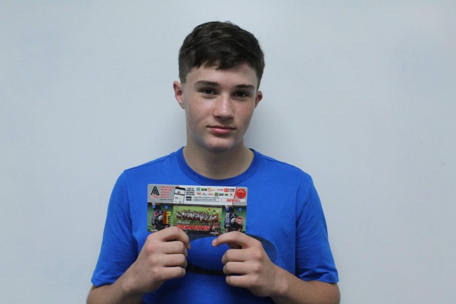 Nathan Henry, eighth-grader, shows off the coupon cards the DMS football team has been selling.