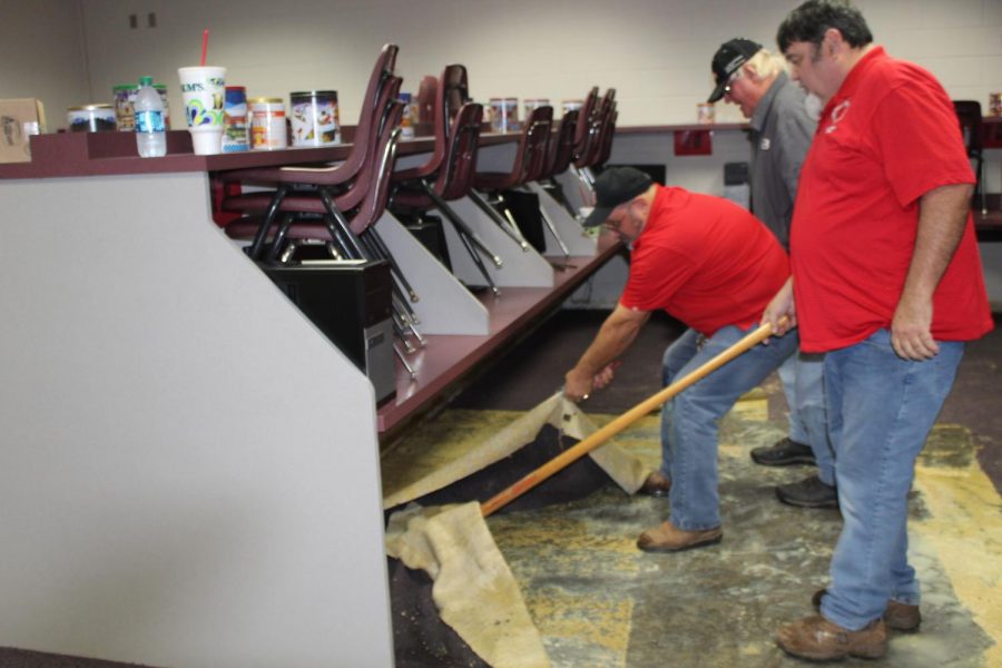 Maintenance workers pull up carpeting in the sixth-grade computer lab.