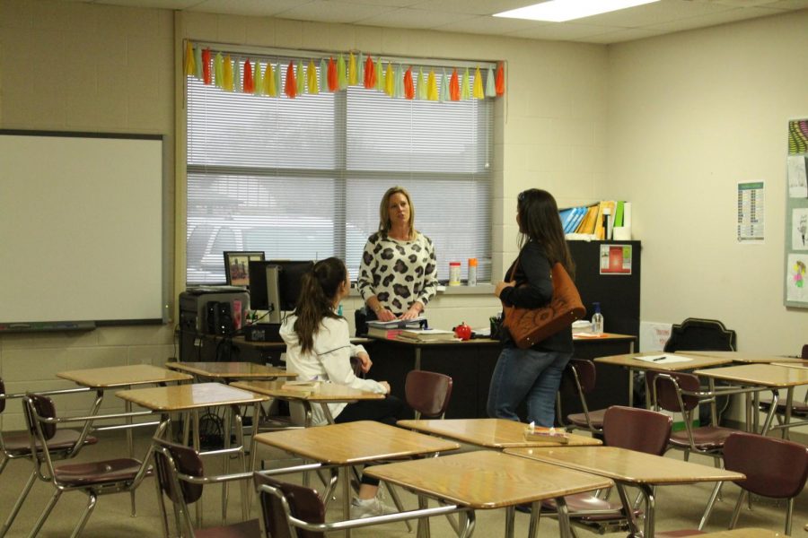 Seventh-grade English teacher Kelly Jones meets with a parent during parent/teacher conferences.