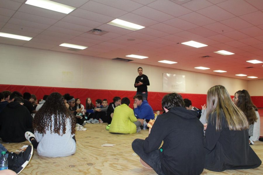 Richey Large, Southwest Oklahoma FCA represenative, talks with eighth-grade students Wednesday during FCA.