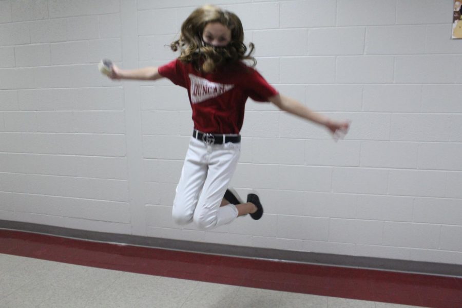 Presley Sanders shows off her cheerleader abilities in the hallway.