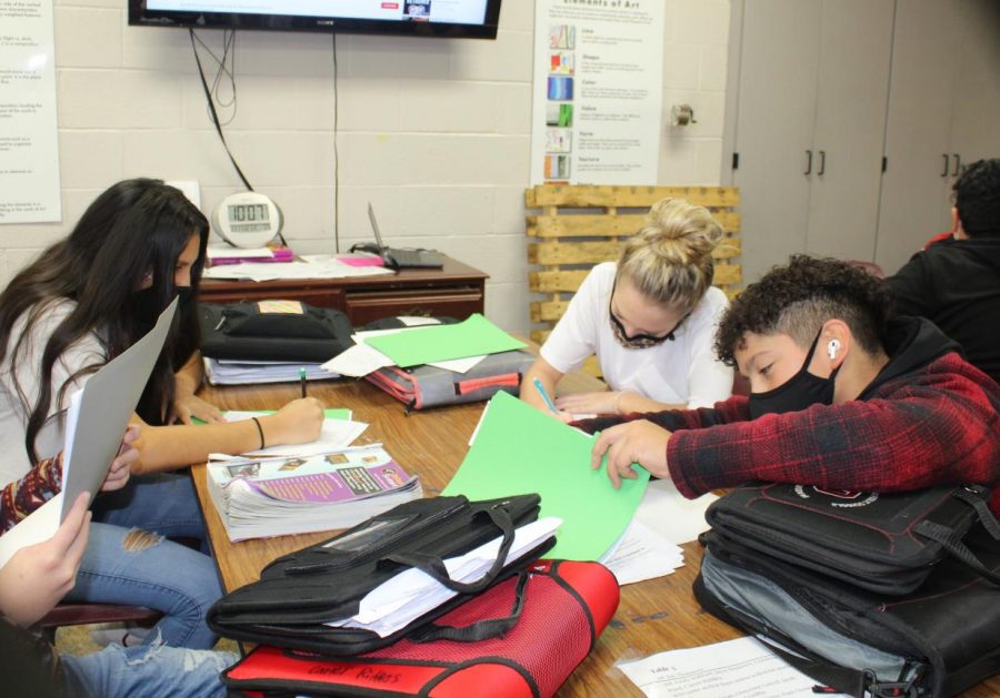 Seventh-grade students work on their comic strips in art class.