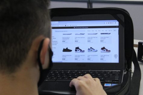 Jackson Lohrer, seventh-grader, looks up different shoe styles online. At DMS, there are plenty of students ready to show off their shoe game.