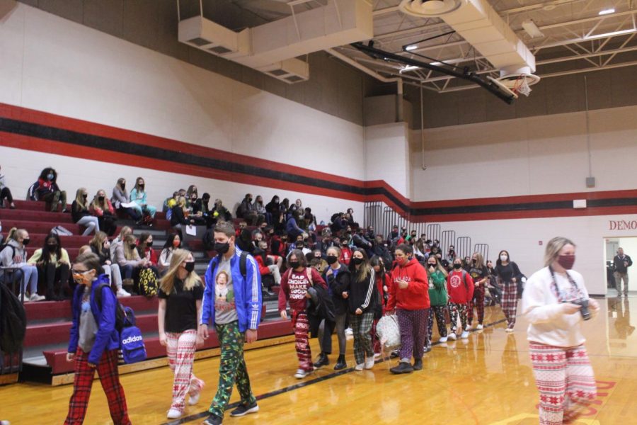 Students walk in a parade around the gym as part of this weeks dress-up theme.