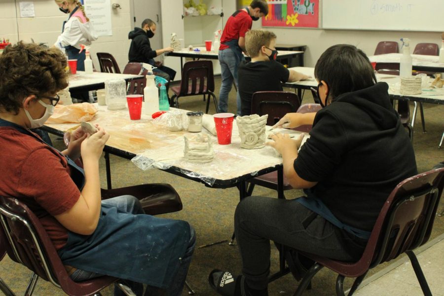 Andrew Gaither and Dawson Ellison, both seventh-graders, design pottery projects in art class.