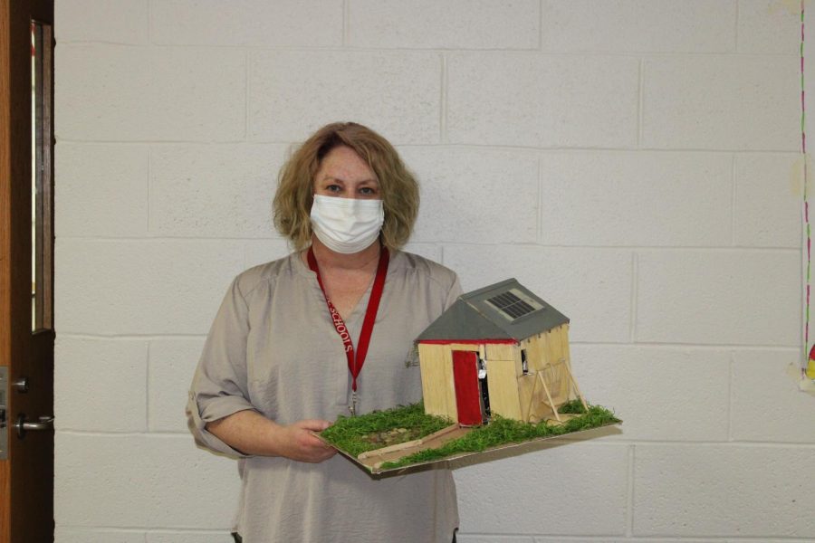 Rosie Castle shows off an example of the type of shed eighth-grade STEM students are creating.