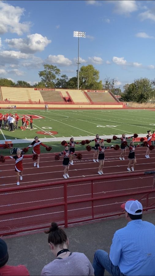 Duncan Middle School cheerleaders cheer during a football game.