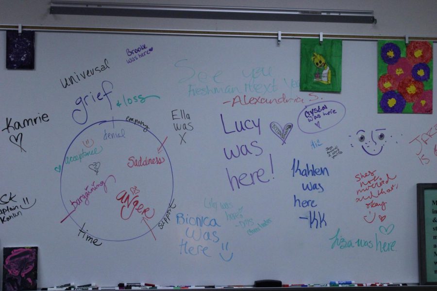 Ms. Davis writes encouraging words on her whiteboard