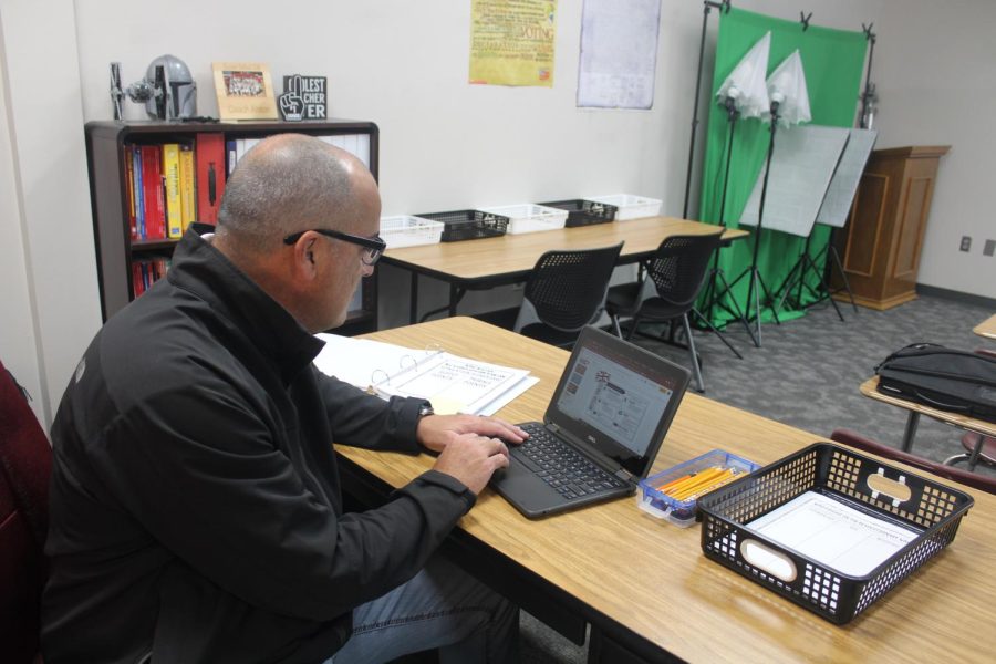 Coach Alston works on his computer while teaching his class
