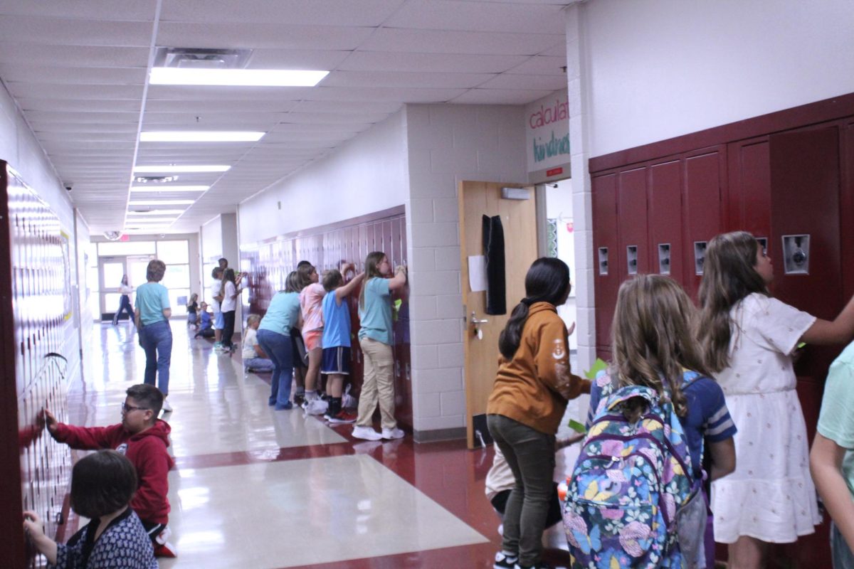 Sixth grade students practicing opening their lockers after summer break
