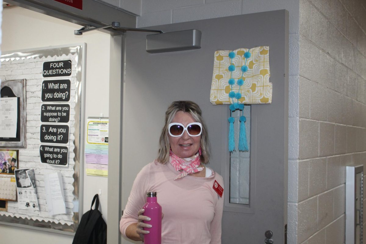 Kerry Wilson, honors English teacher, shows off her Barbie look for Barbie and Ken Day.