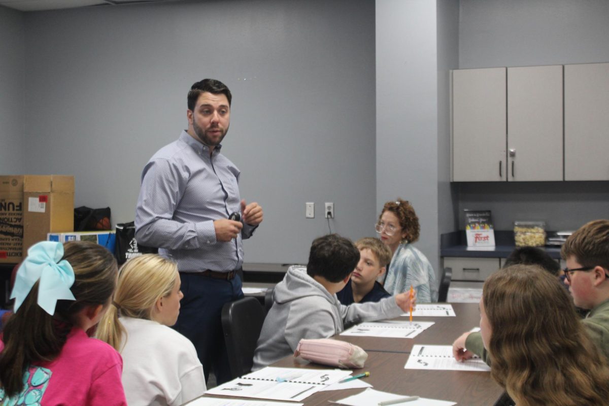 Andrew Aldridge works with seventh-grade PROS members during a training in September.
