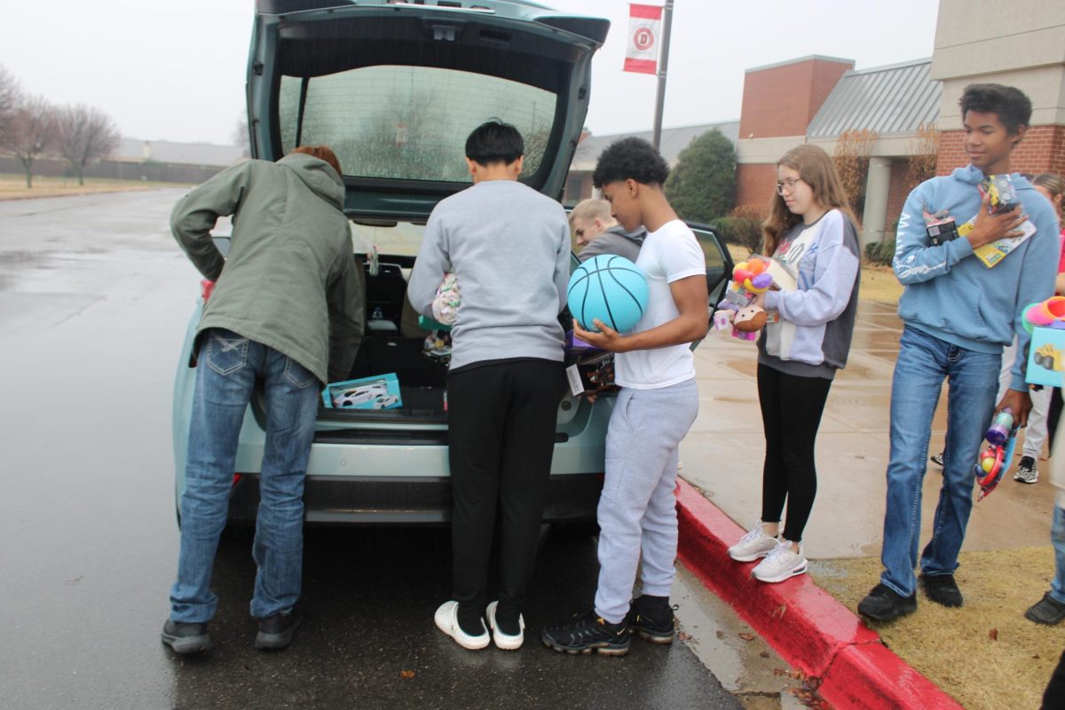 Students load donated toys up before taking them to The Duncan Toy Shop.