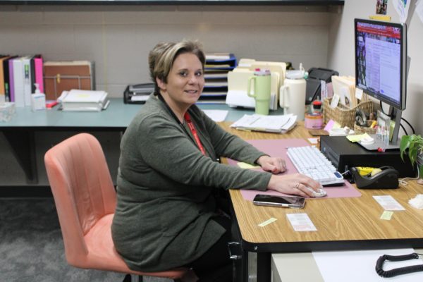 Morgan Cottany poses for a picture while working at her desk.