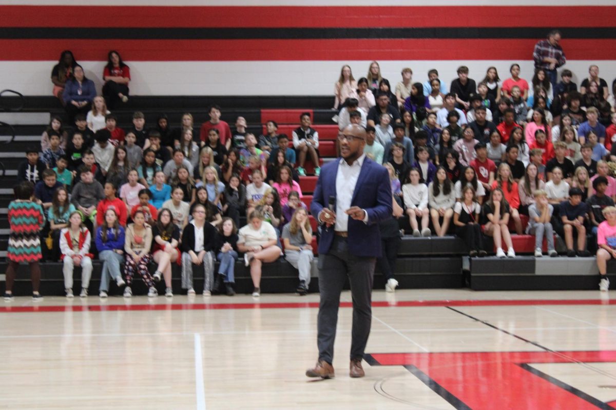 Donovan Woods, former NFL player, address the Duncan Middle School student body on Thursday.