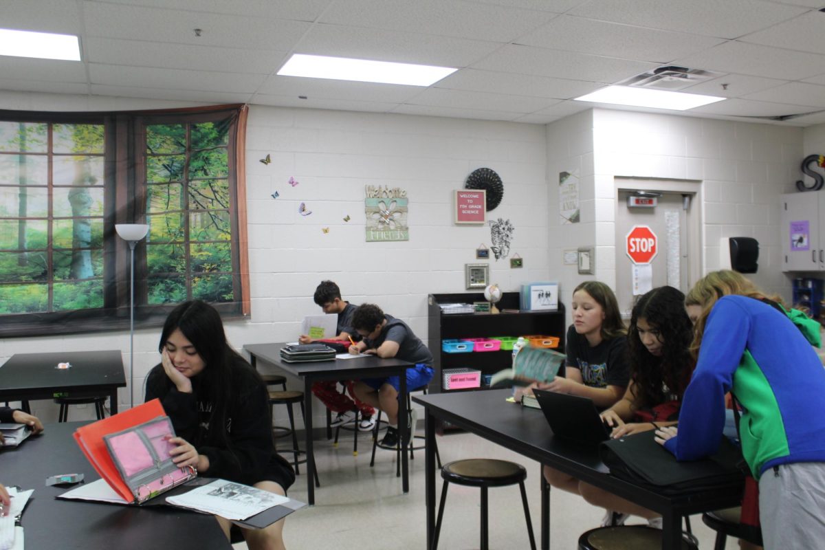 Students in Stacy Pena's science class work on their assignments by using paper. Wi-Fi for the seventh-grade hall was down for several days.