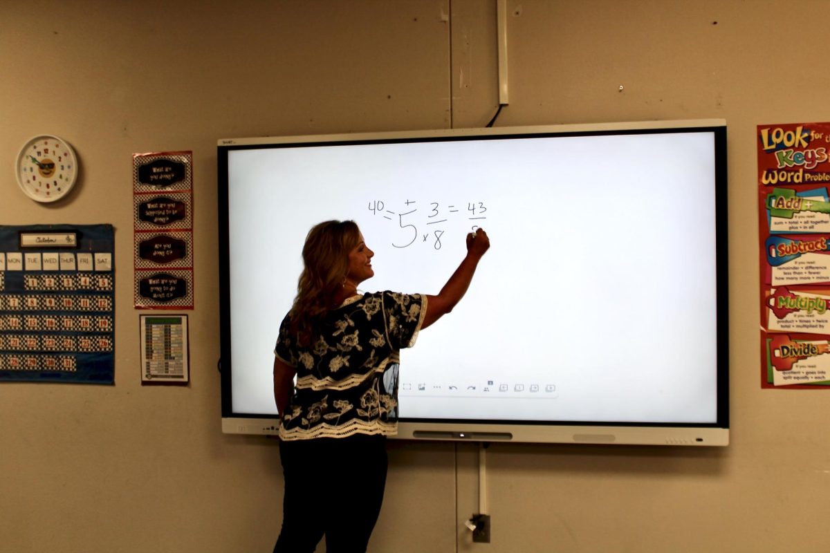 Marinda Cook uses her new SmartBoard to teach a math lesson. Seven teachers got new SmartBoards in their classrooms.