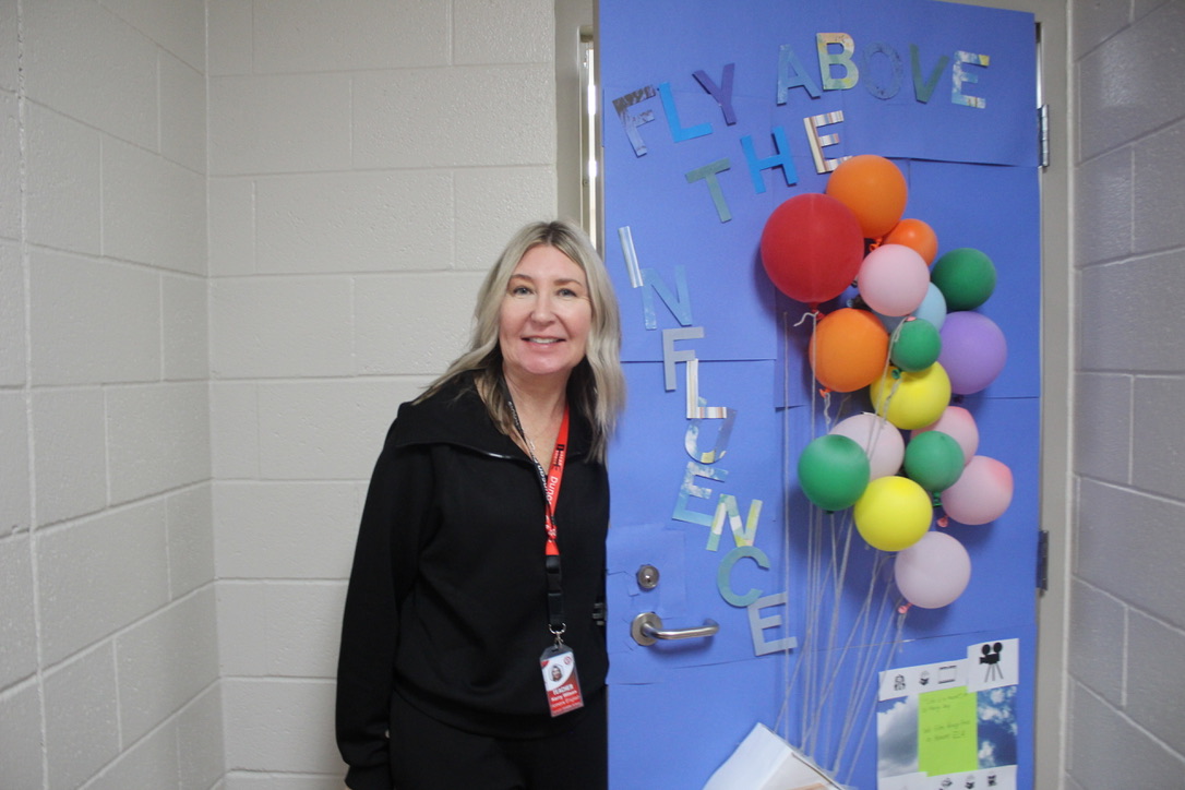 Kerry Wilson shows off her door that was decorated for Red Ribbon Week. Wilson's first hour class was the winner of the door decorating contest for the week.