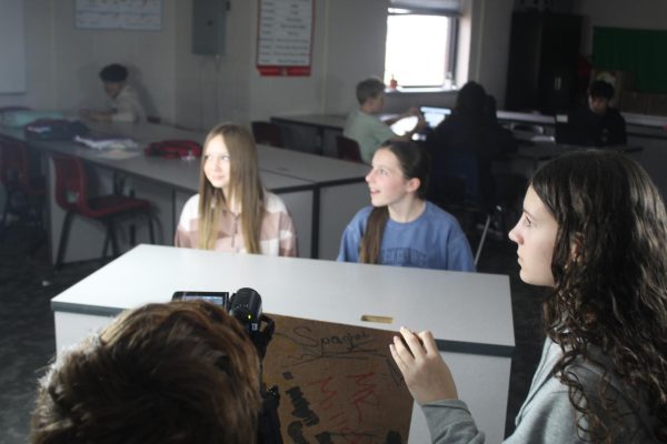 Members of the Demon Direct newspaper staff work on the weekly video news update.