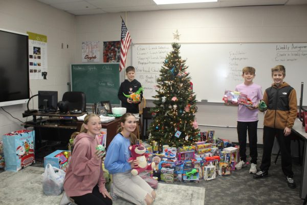 Seventh-grade NJHS officers show off the items that were donated during the annual toy drive. The toys were donated to the Toy Shop of Duncan.