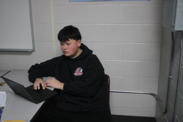 Justin Bettencourth works on his Chromebook in class. Bettencourth is one of several students who talked about the benefit of cell phones at school.