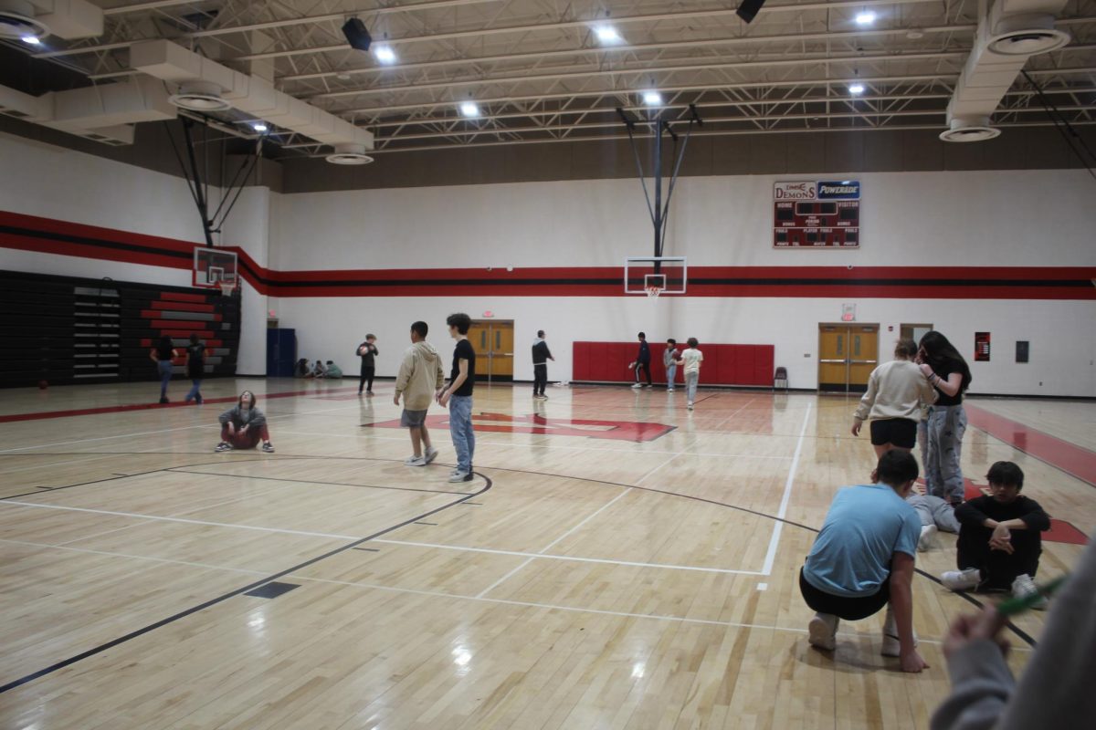 Students enrolled in PE use the basketball court during class to play basketball.