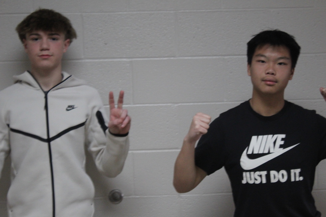 Christians Gates, left, and Peng Zhang take part in a photo shoot for the Demon Direct. Gates is the student life editor, while Zhang is the yearbook editor in chief.