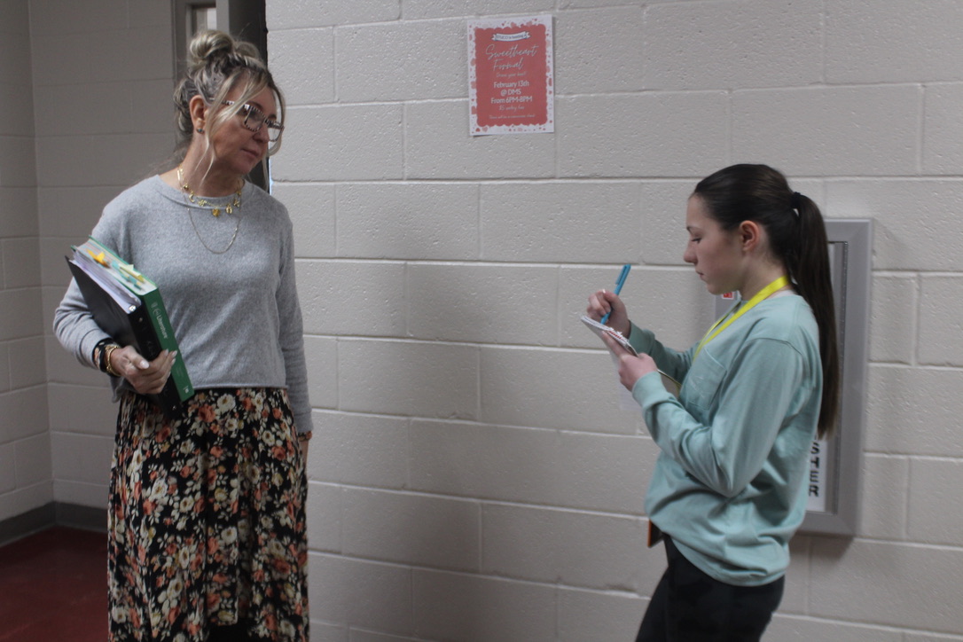 Ellie Edwards, right, interviews English teacher Kerry Wilson as part of a story assignment.