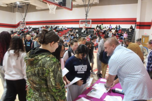 Students gather at the Youth Coalition table to sign up for the club this year.