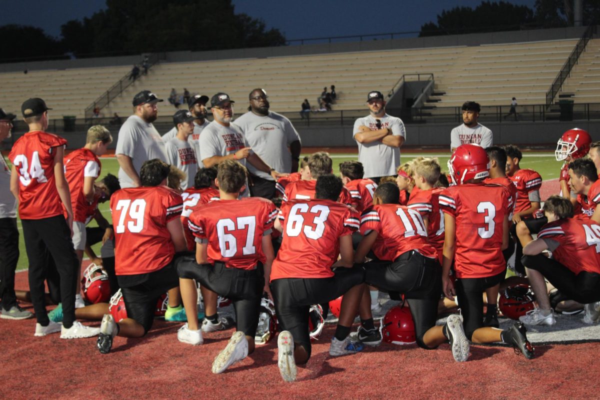 Eighth-grade football players huddle up during the game against Lawton Ike on Tuesday.