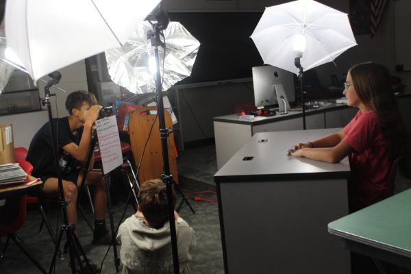 Lillie Goble and Gabriel Hernandez read through the new update information as the camera rolls.
