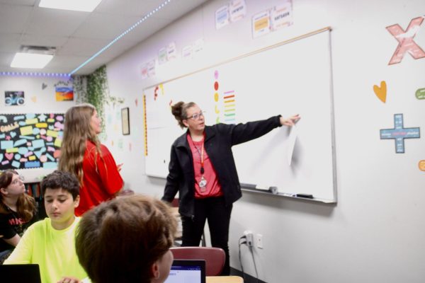 Melanie Harris with on a math concept with a seventh-grade student.