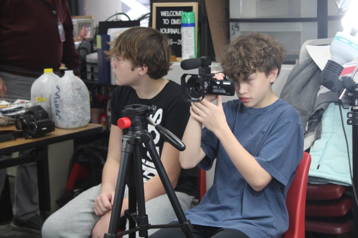 Cash McRoy tests out the camcorder prior to filming the News Update.