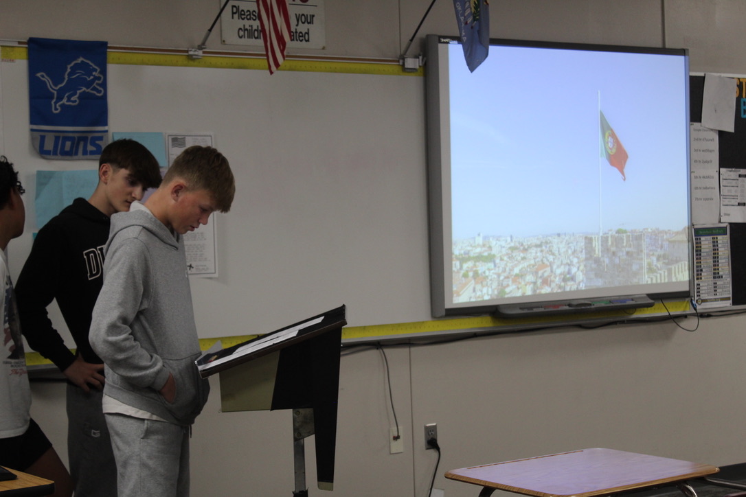 Adler Trammel, along with his teammates, present on their country for social studies.