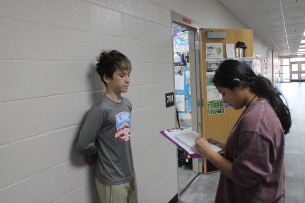 Zander Huff gets interviewed about swim. Huff was one of the swim team members who broke records this season.