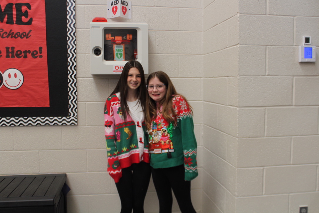 Delaney Ward and Isla Martin show off their ugly Christmas sweaters.