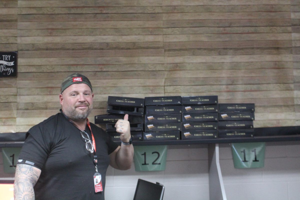 Steven Dixon shows off the chess boards he uses for Chess Club at DMS.