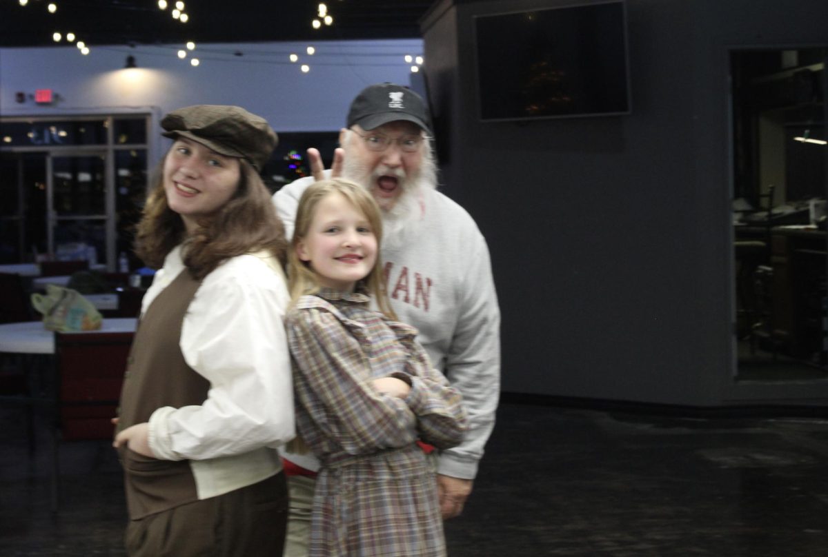 Duncan Middle School students Stevvie French and Chloe Brown pose for a photo with "A Christmas Carol" director Michael Harris.