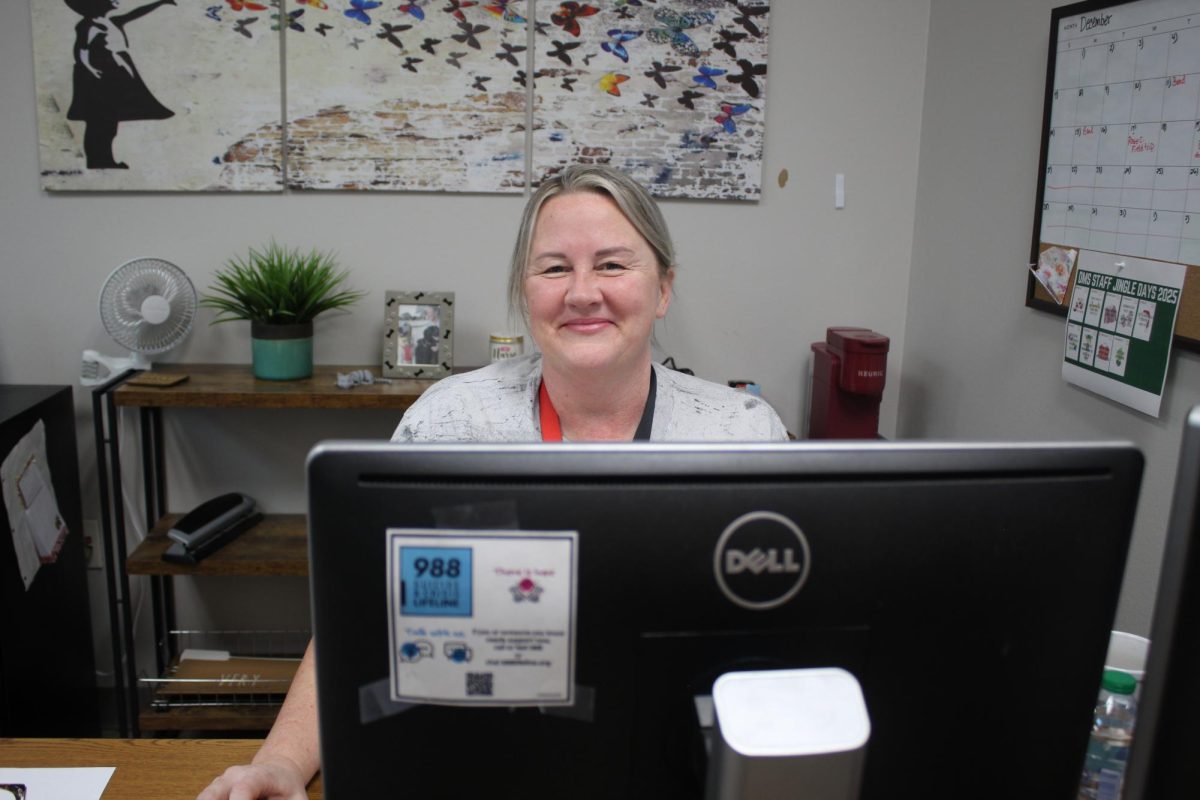 Nurse Crystal Ford works at her computer. Ford encouraged students to wash their hands to prevent the spread of germs.